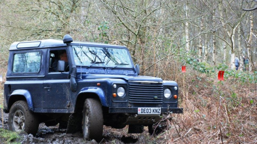 Side view of a 4x4 turning on a mud track